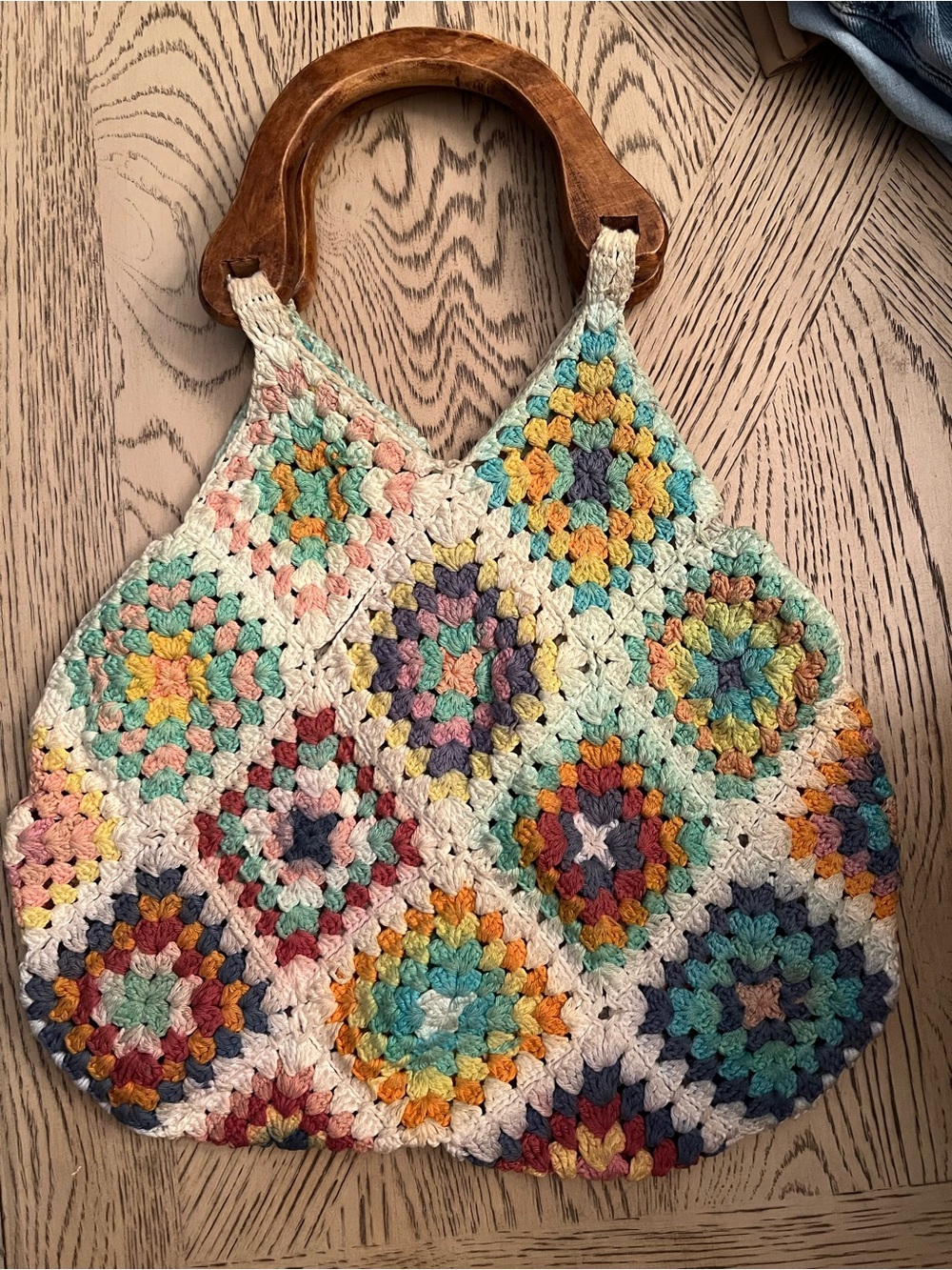 Noonday Collection model, a retro-inspired diamond patchwork pattern handbag